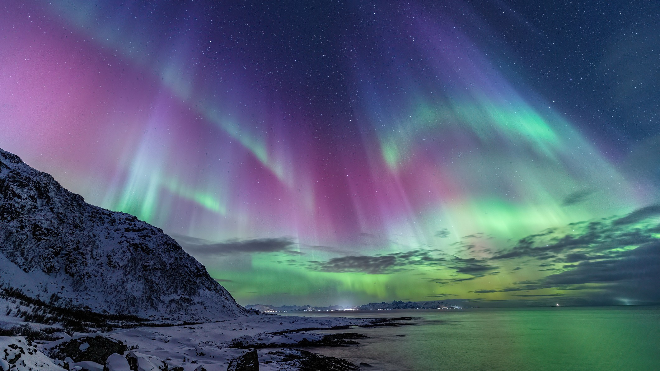 Aurora Borealis over a dark landscape